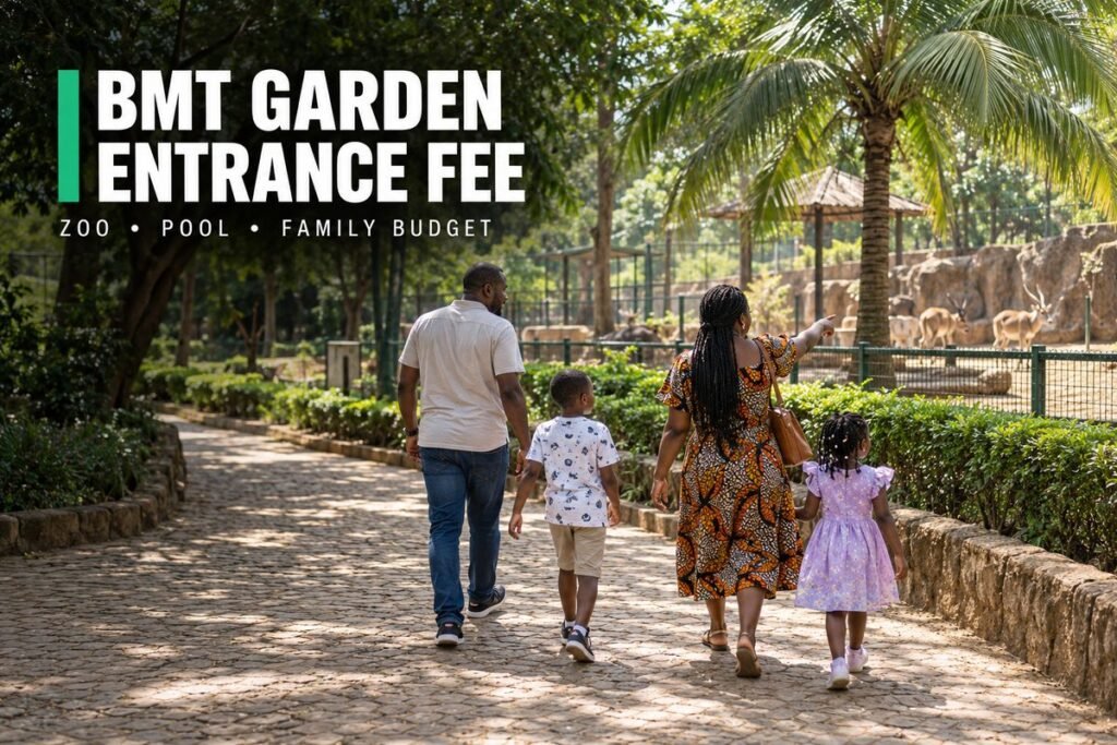 Family walking along a shaded garden path past a small zoo enclosure with a palm tree in a city park